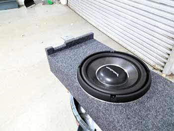 2011 Cadillac CTS. System components: Audio Control controller with remote level controller. Rockford Fosgate amps and slim woofer. Kenwood component spkrs and 5.25" coax spkrs. Built custom box to suspend from rear deck to fire straight through oem sub opening. Amps housed in side of trunk with trim panel. Remote controller mounted in dash.