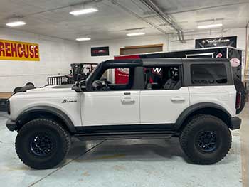 This is  a white 2020 Ford bronco Badlands edition. We installed a 12 " stinger  swinggate enclosure and an Amplifier.