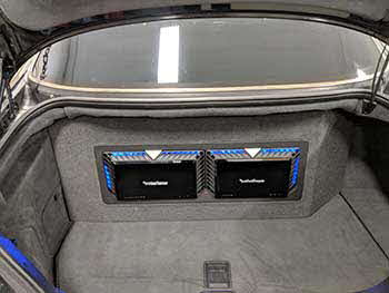 2004 Mercedes Benz S55AMG - Installed Kenwood entertainment in the dash, Kenwood speakers in front & rear. Pulled the OEM sub out of the rear deck to allow the custom fabricated enclosure to vent through. Enclosure housed 2 pr Rockford 12" subs and 2 Rockford amps. Trimmed with matching carpet/vinyl and blue accent lighting.